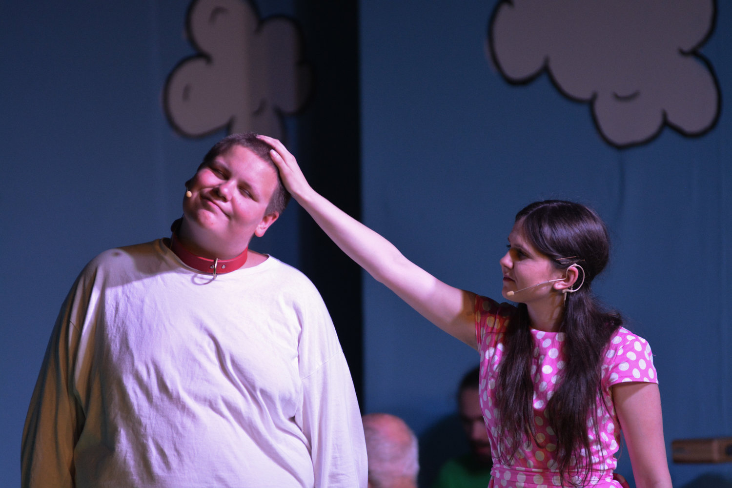 An actress portraying Sally Brown gives a pat on the head to Snoopy in a scene during “You’re a Good Man, Charlie Brown” on Thursday, July 28.
