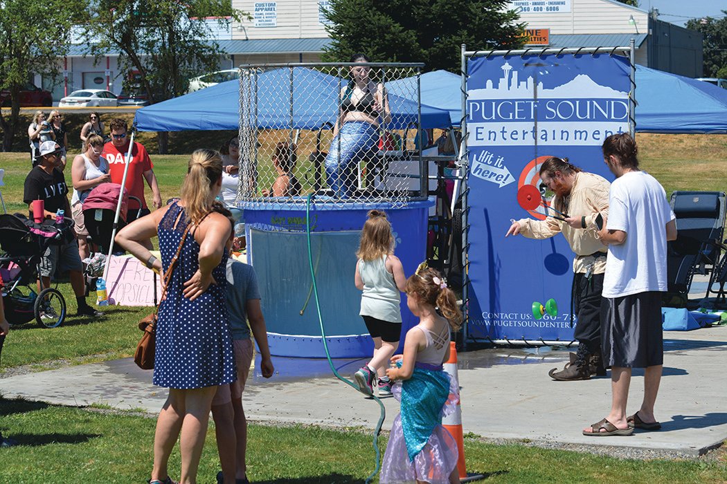 Young attendees try to dunk a mermaid at the Mermaid Fest at Yelm City Park on Saturday, July 30.