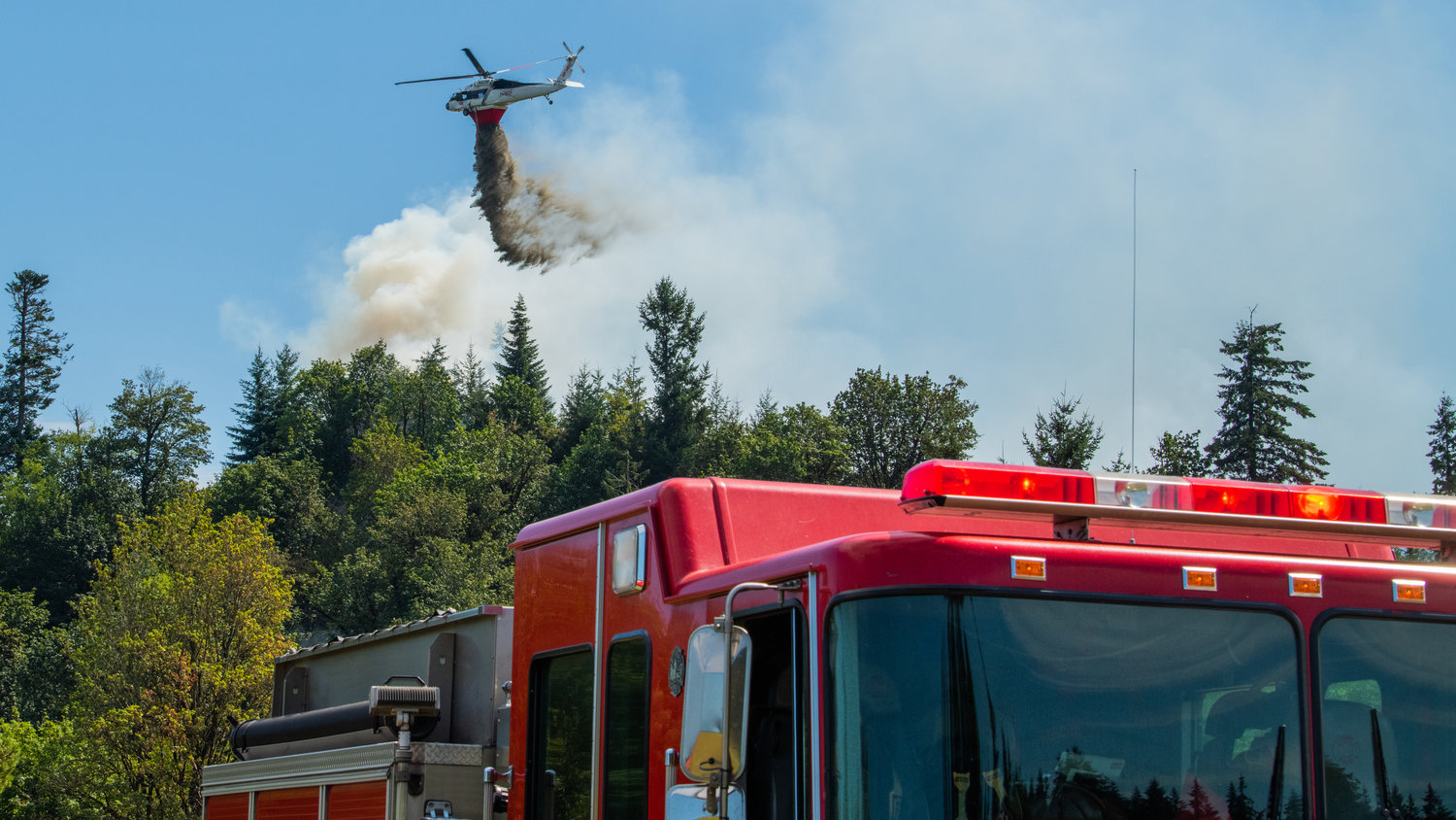 A Department of Natural Resources helicopter dumps water from the Skookumchuck River on a forest fire near Bucoda Monday afternoon.