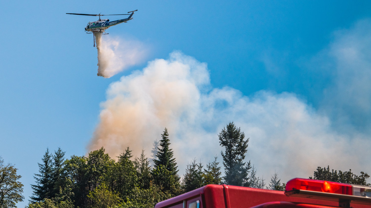 A Department of Natural Resources helicopter flies over Bucoda Monday afternoon while responding to a forest fire near the intersection of Highway 507 and Troy Avenue.