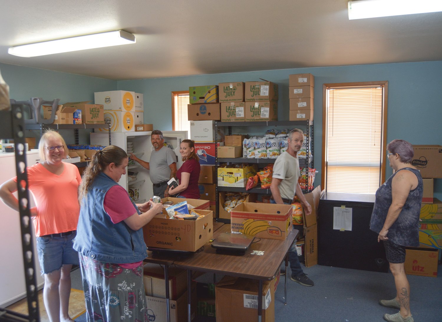 Volunteers with the First Baptist Church of Yelm help serve shoppers their groceries from the food pantry.