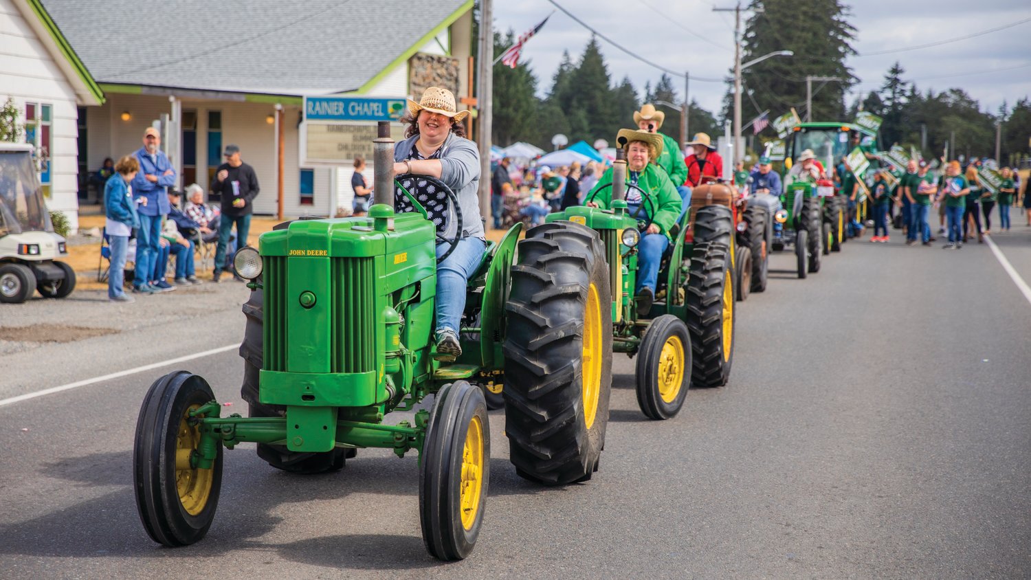 John Deere tractors line state Route 507 on Saturday during the Rainier Round Up Days parade.