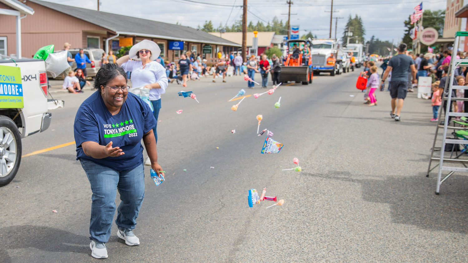 Candy is thrown during the Rainier Round Up Days parade Saturday morning along state Route 507.