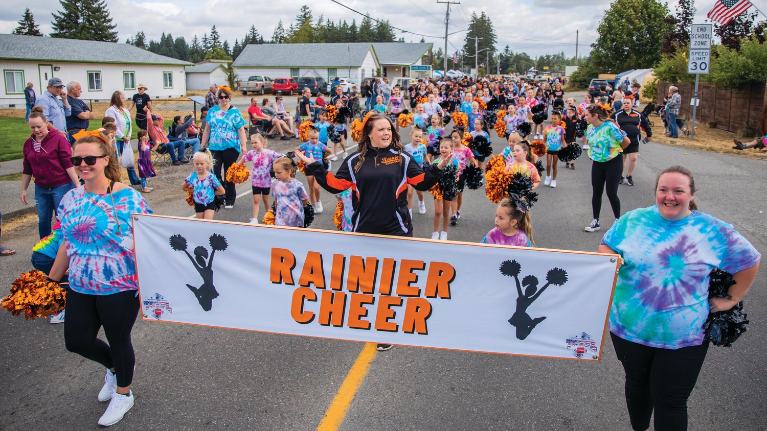 Rainier cheerleaders shake their pom-poms during the Round Up Days parade Saturday morning along state Route 507.