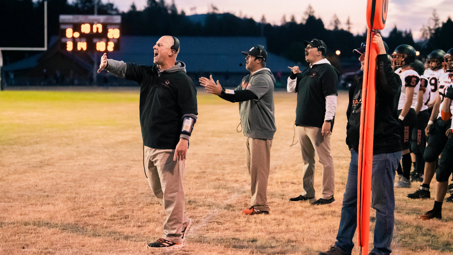 Napavine coaches yell to players on the field during a game in Rainier Friday night.