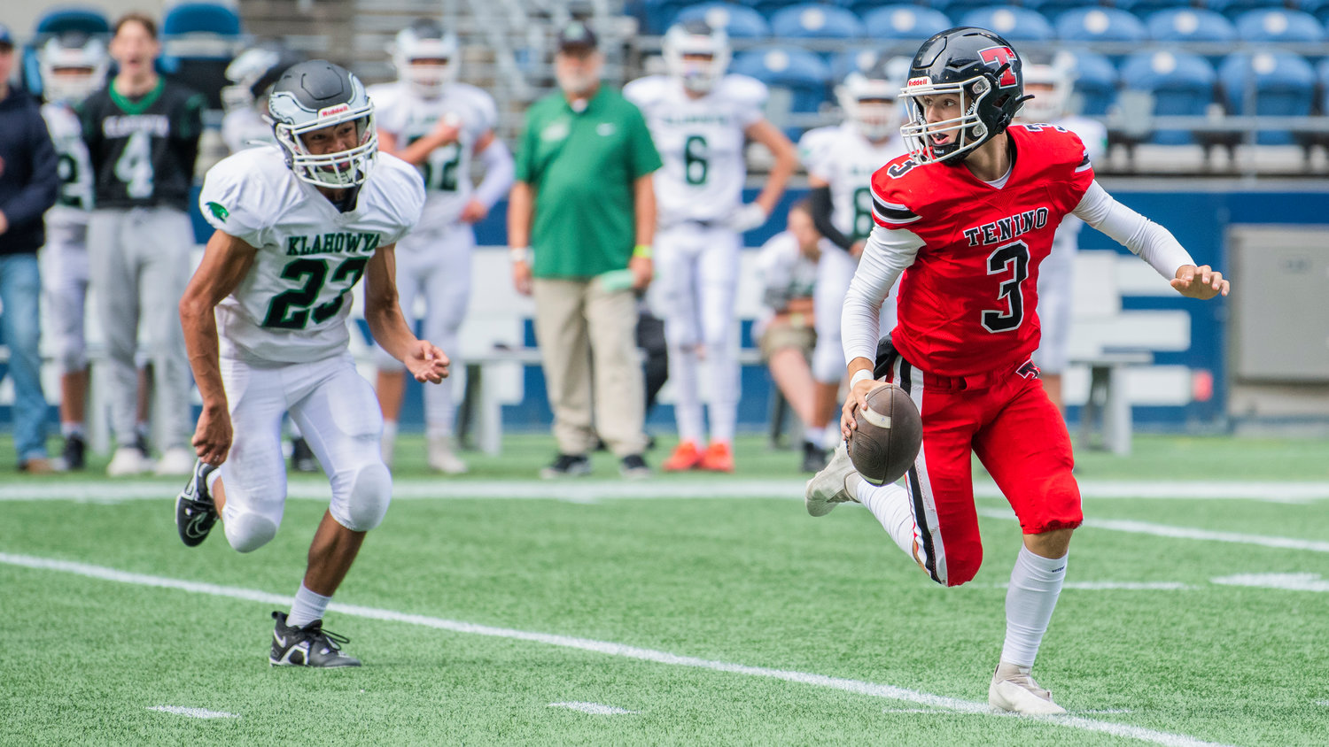 Tenino quarterback Cody Strawn (3) scrambles out of the pocket while looking to pass Saturday afternoon at Lumen Field in Seattle.