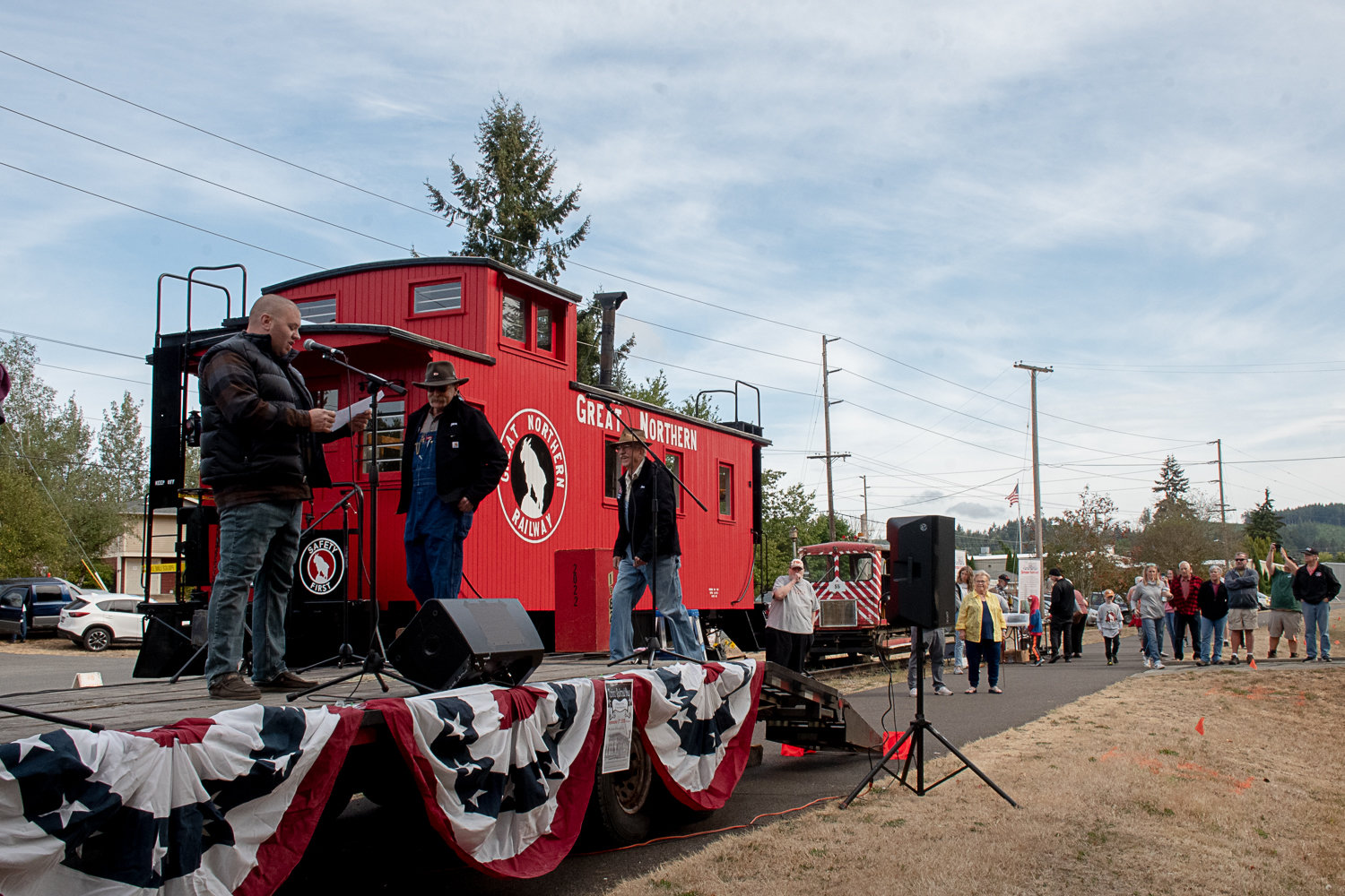 Tenino Mayor Wayne Fournier introduces Don Bowman, of Olympia, and Jan Wigley, of Centralia, at the ribbon-cutting ceremony to open the restored caboose at the Tenino Depot Museum on Saturday morning.