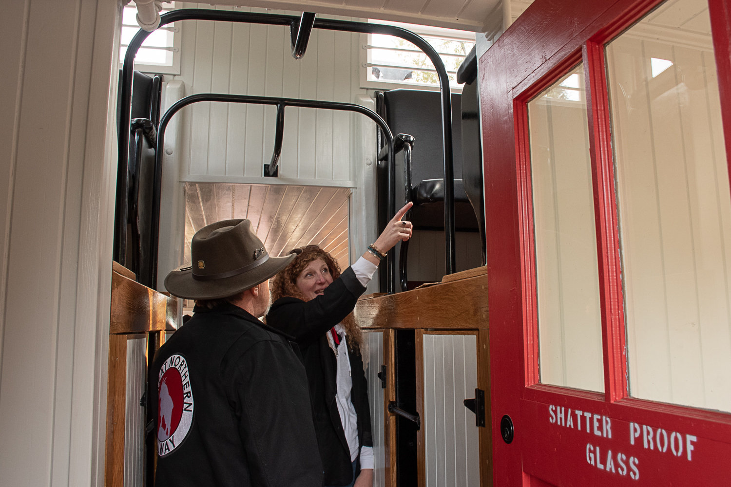 Fae Widenhoeft, of the band SeaStar, points out where she used to keep her outfits in the cupola to Don Bowman, one of the two men who restored the nearly 100-year-old caboose.
