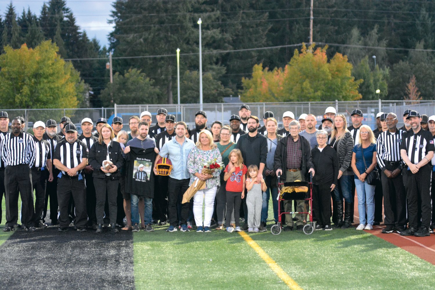 The Kain family poses for a photo with many of their father's colleagues on Sept. 29.