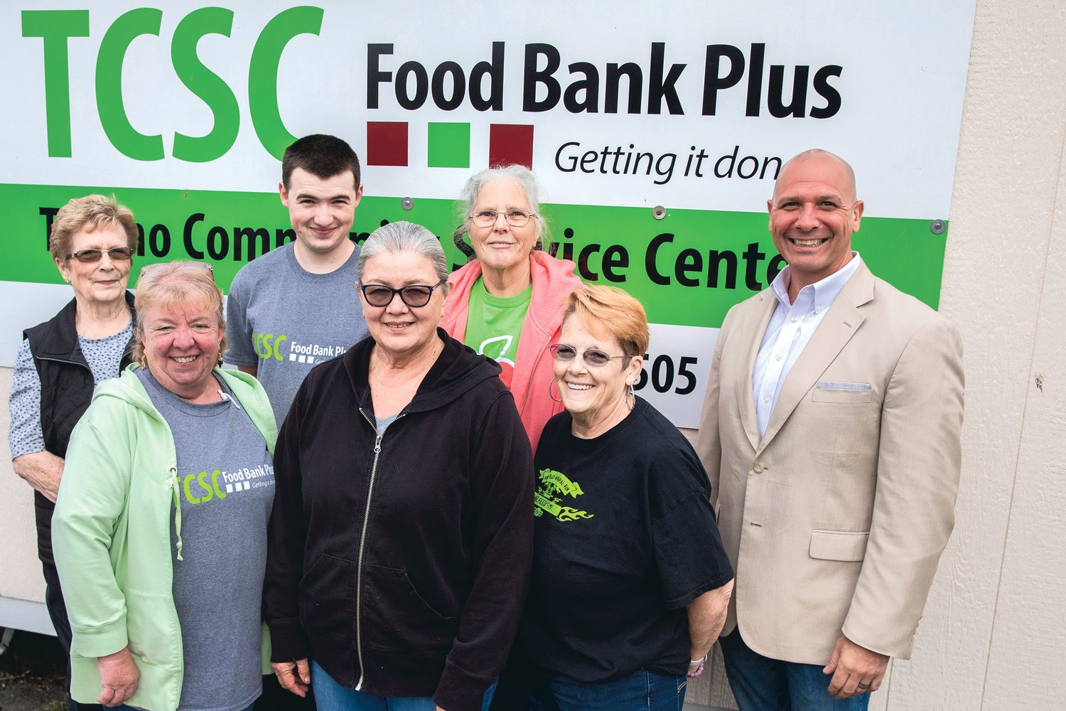 State Rep. Peter Abbarno, right, smiles for a photo with employees and volunteers at the Tenino Community Service Center Food Bank Monday morning during a tour of the facility.