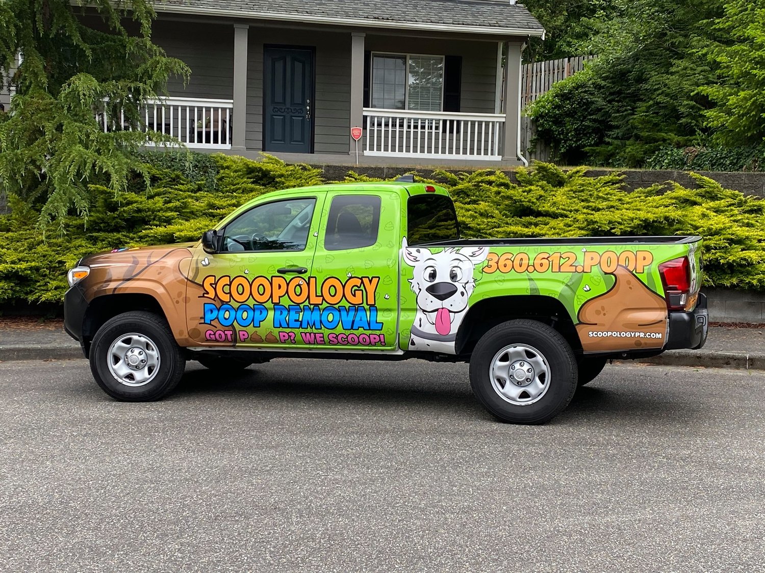 A vehicle with the pet waste removal company, Scoopology, advertises the business’ services.