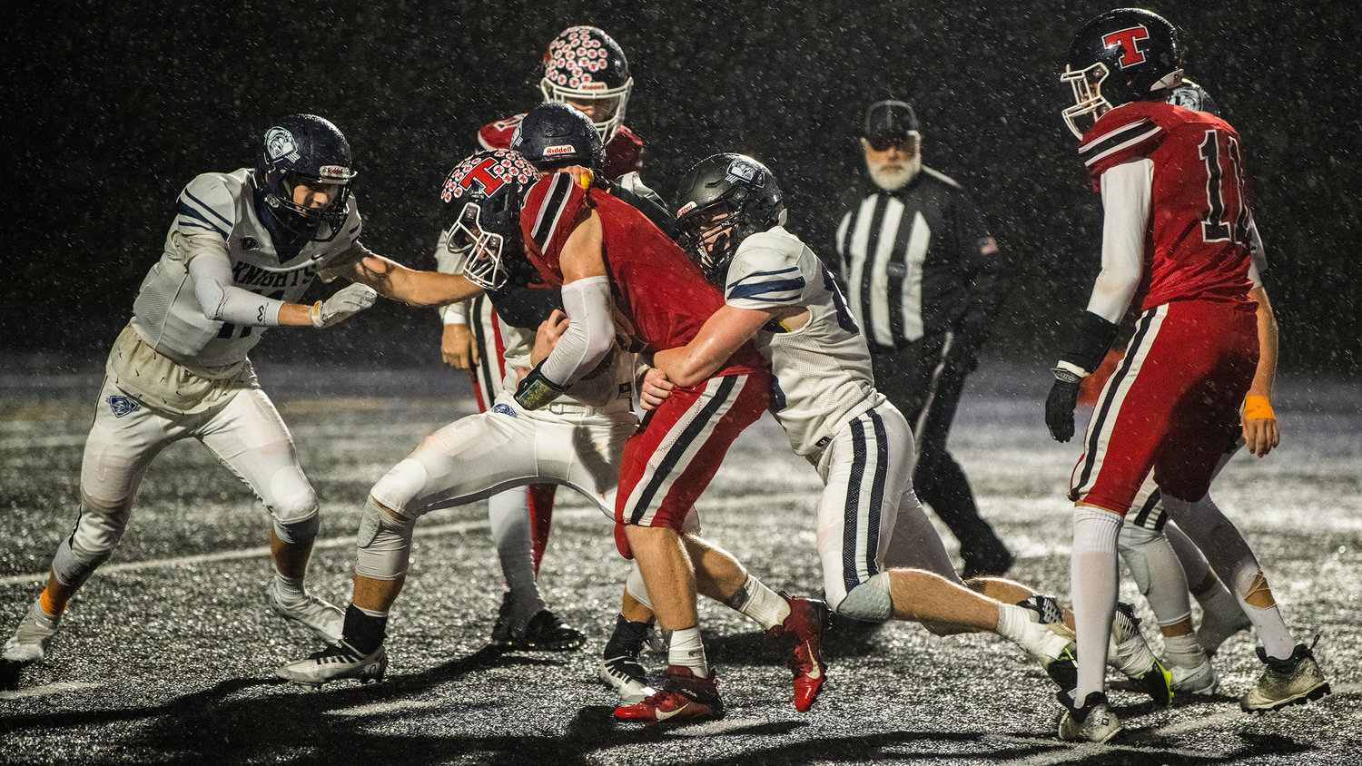 Tenino sophomore Austin Gonia (2) runs with the football Friday night at Beaver Stadium during a game against the King’s Way Christian Knights.