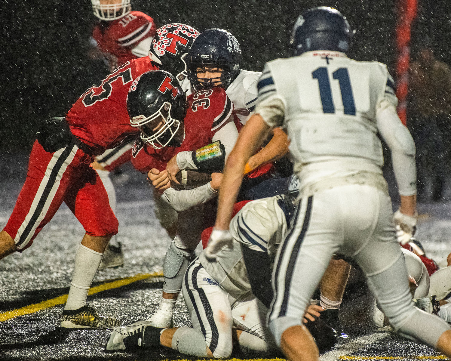 Tenino sophomore Tyler Minerich (33) wraps up the football on a run Friday night at Beaver Stadium during a game against the King’s Way Christian Knights.