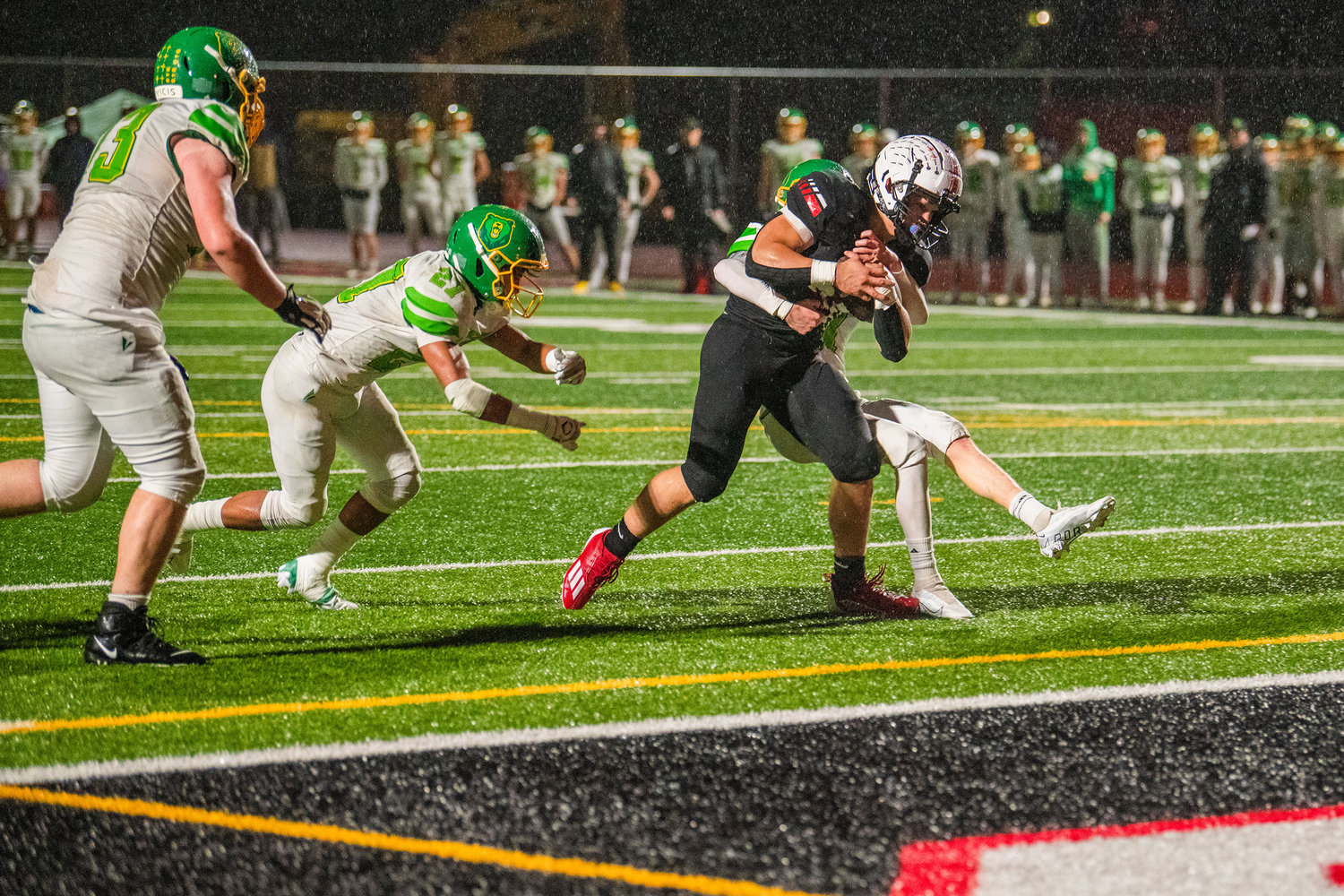 Yelm senior William Carreto (30) blasts through defenders with the football for a touchdown Friday night.