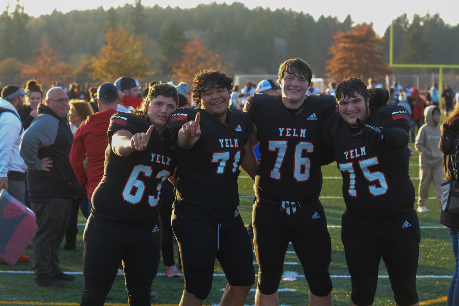 Offensive linemen Jonah Smith (63), Ami Fakava (71), Tyler Blevins (76) and Landen Barger (75) pose for a photo in celebration of their 3A quarterfinal victory on Saturday, Nov. 19.