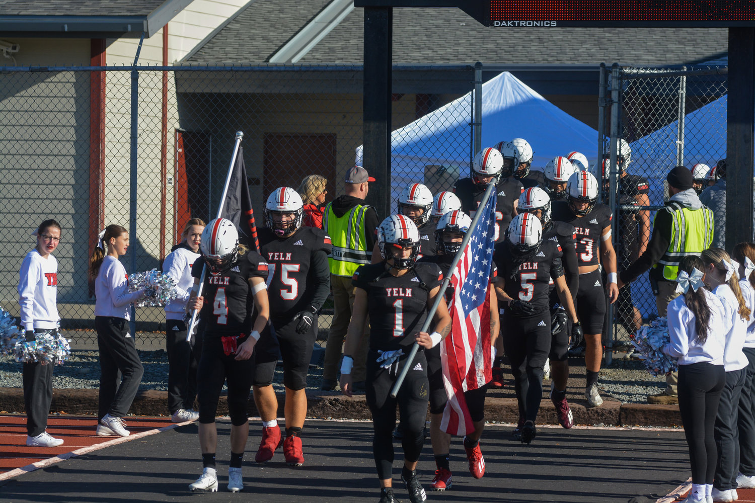 Seniors Aden Schaler (4) and Ray Wright (1) lead the Tornados onto the field prior to their matchup against Kennewick on Saturday, Nov. 19.