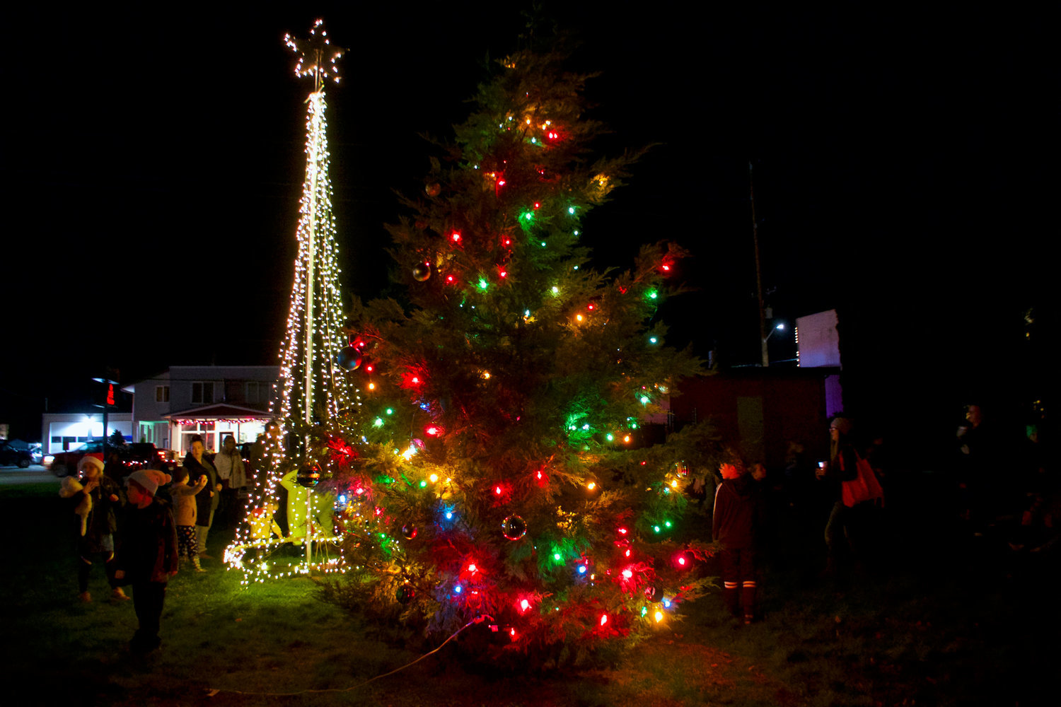 Community members enjoy the Rainier Christmas tree lighting event in this file photo. The cities of Tenino, Rainier and Yelm will all light up their respective Christmas trees this week.