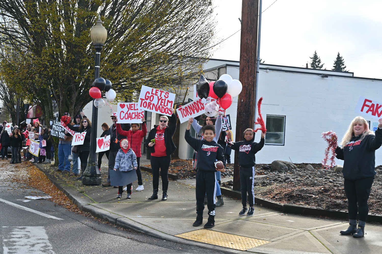 Tornado fans gather on the corner of Yelm Avenue and state Route 507 in support of the Yelm football team, who traveled to Art Crate field to face the Bellevue Wolverines in the 3A state semifinals. The team will compete in the state tournament on Dec. 3.