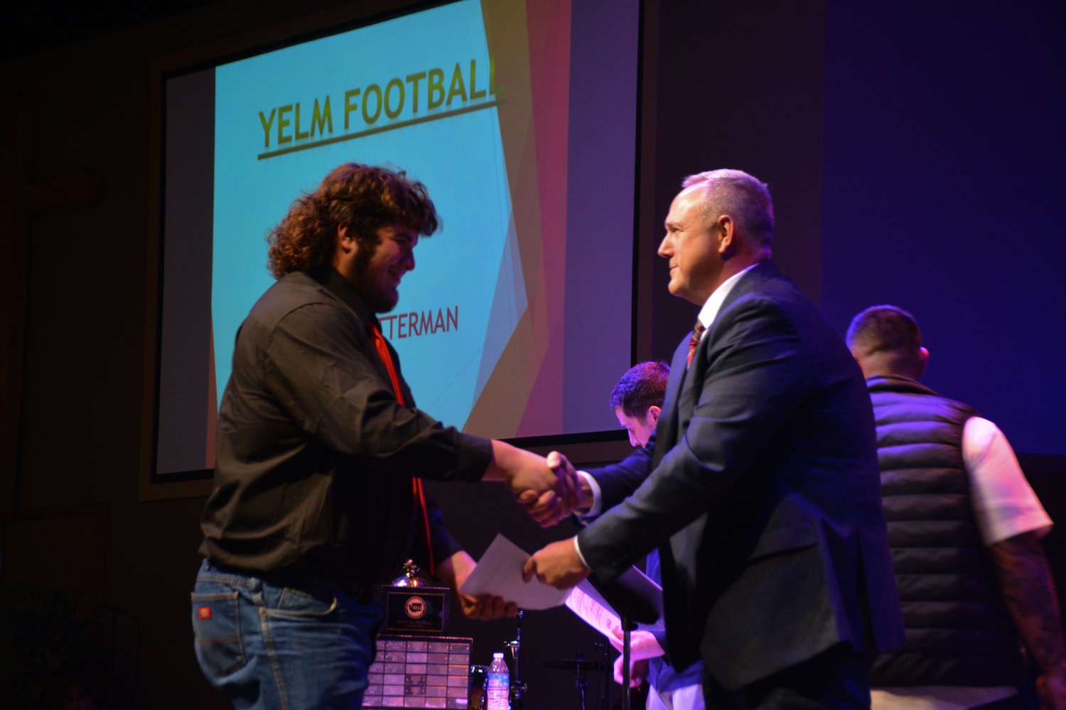 Junior two-way lineman Landen Barger, who was voted South Sound Conference lineman of the year, accepts his varsity letter from offensive line coach Brian Foote.