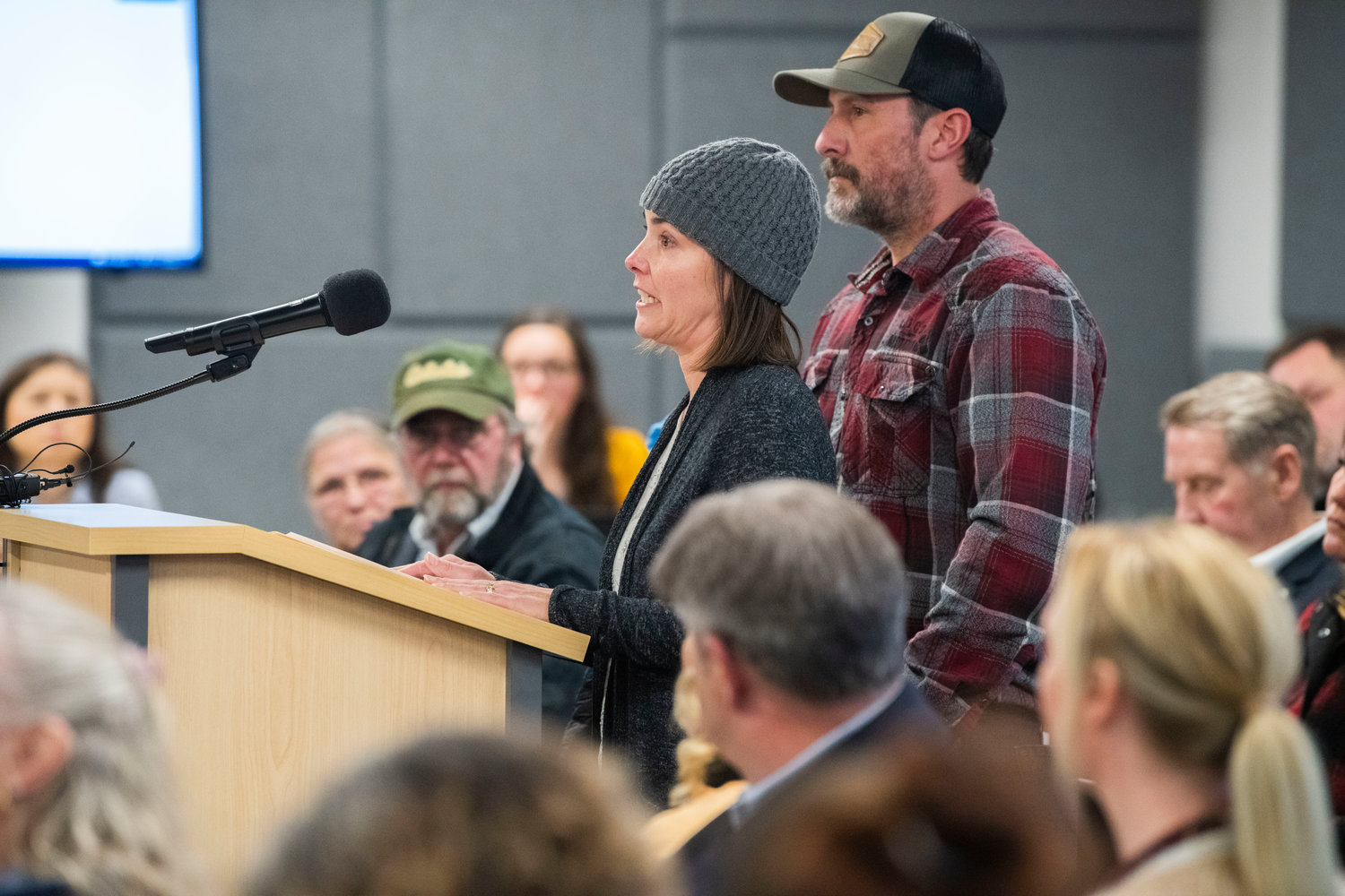 Jennifer Wiens speaks out, with tears in her eyes, against a Supreme Living facility on property she once owned in Tenino.