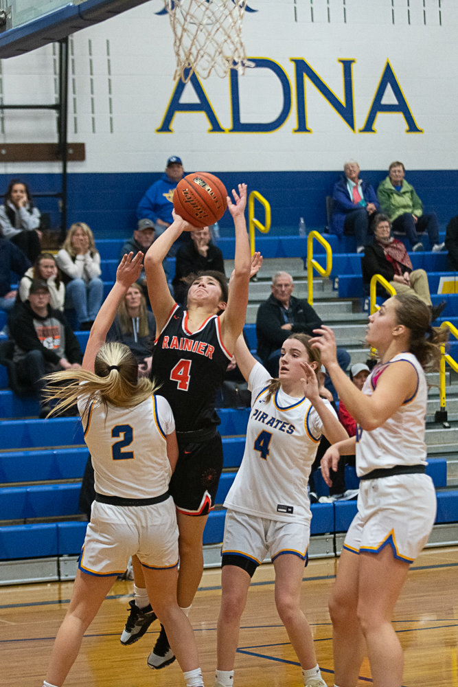 Rainier's Angelica Askey barrells through Danika Hallom on her way to the rim during the second half of the Mountaineers' 51-47 loss to Adna on Jan.19.