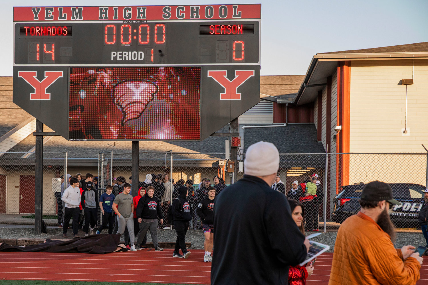 Athletes walk onto the football field in Yelm as Tornado fans cheer following a 14-0 season.