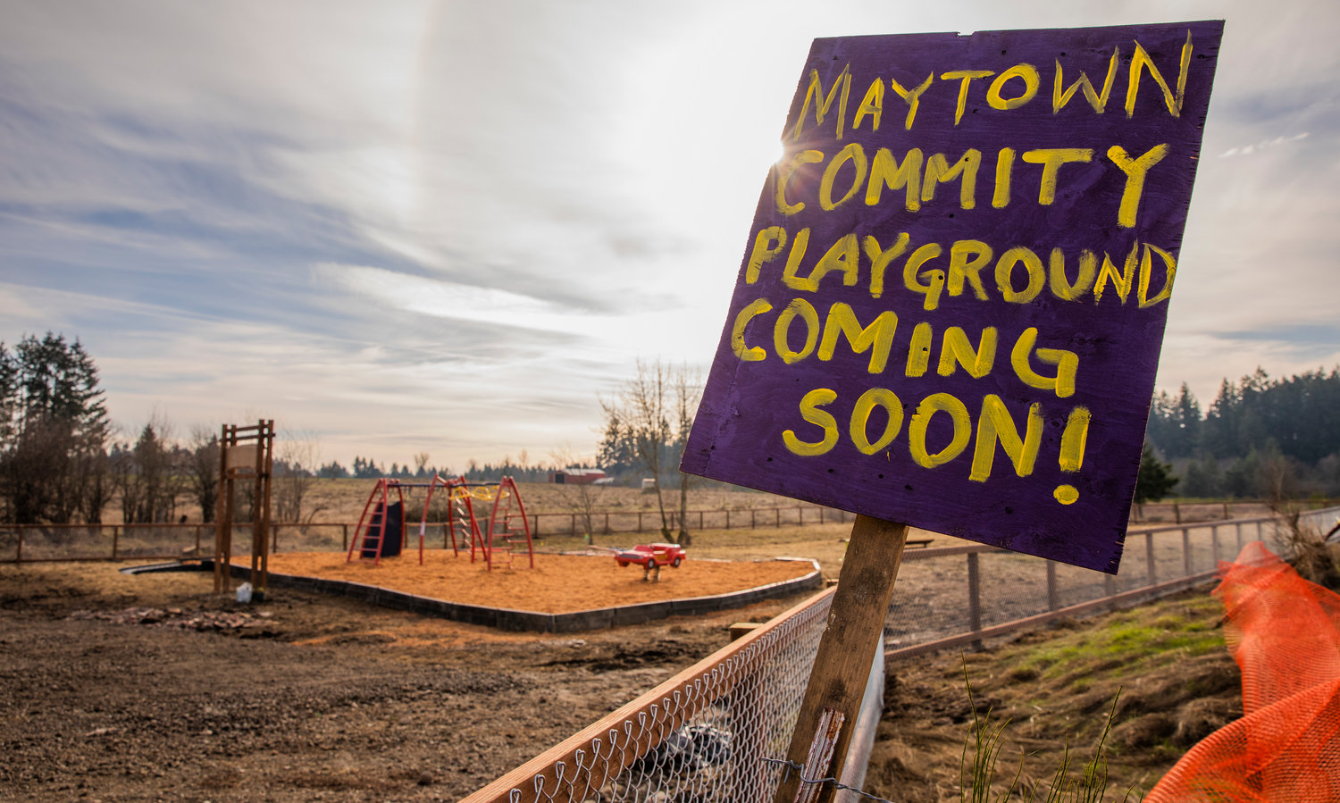 Sun shines behind a sign for the Maytown Community Playground, which is located next door to the Supreme Living facility, on Wednesday.