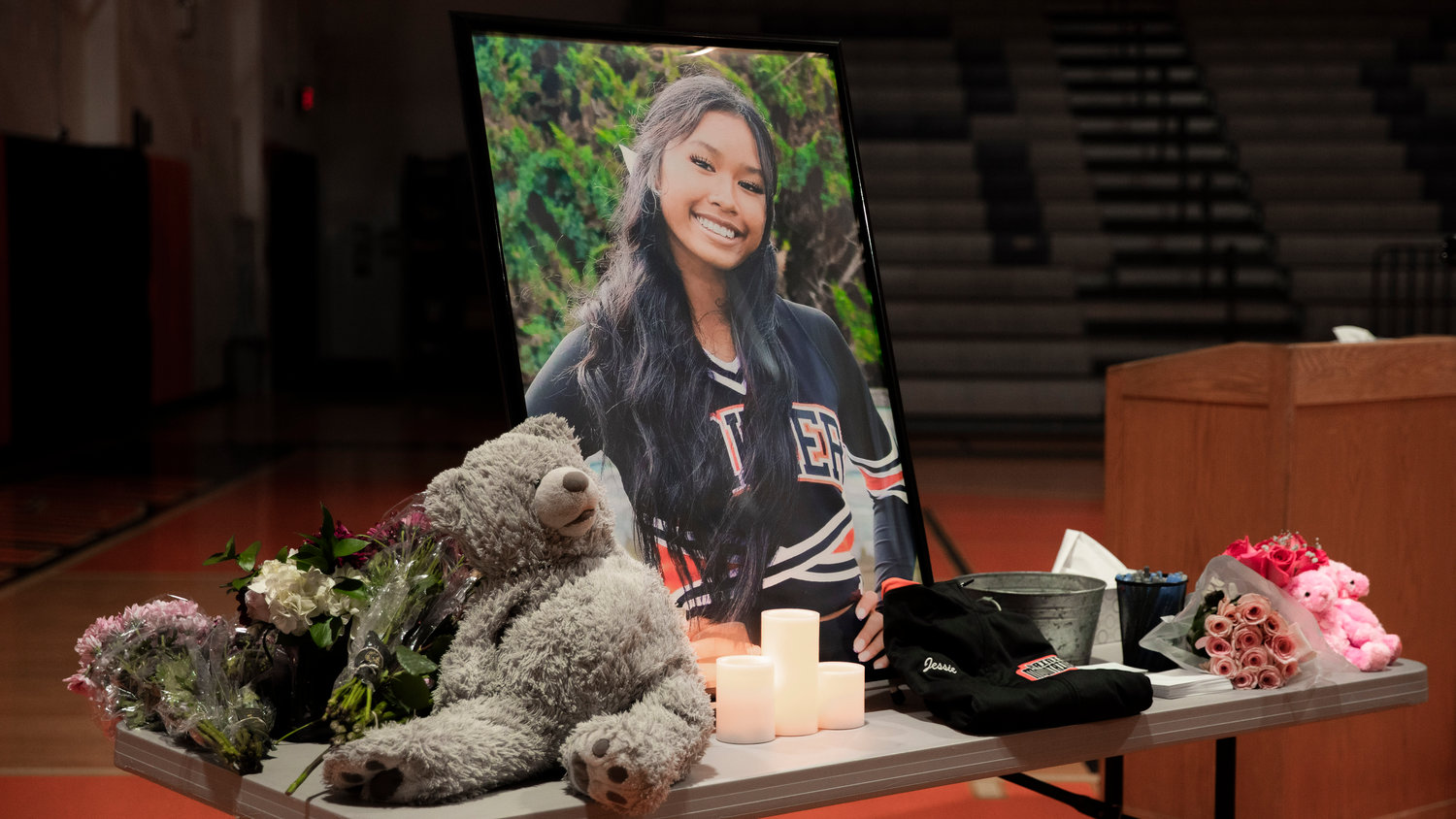 A portrait of Jessie Uch is displayed during a vigil held at Rainier High School on Tuesday.