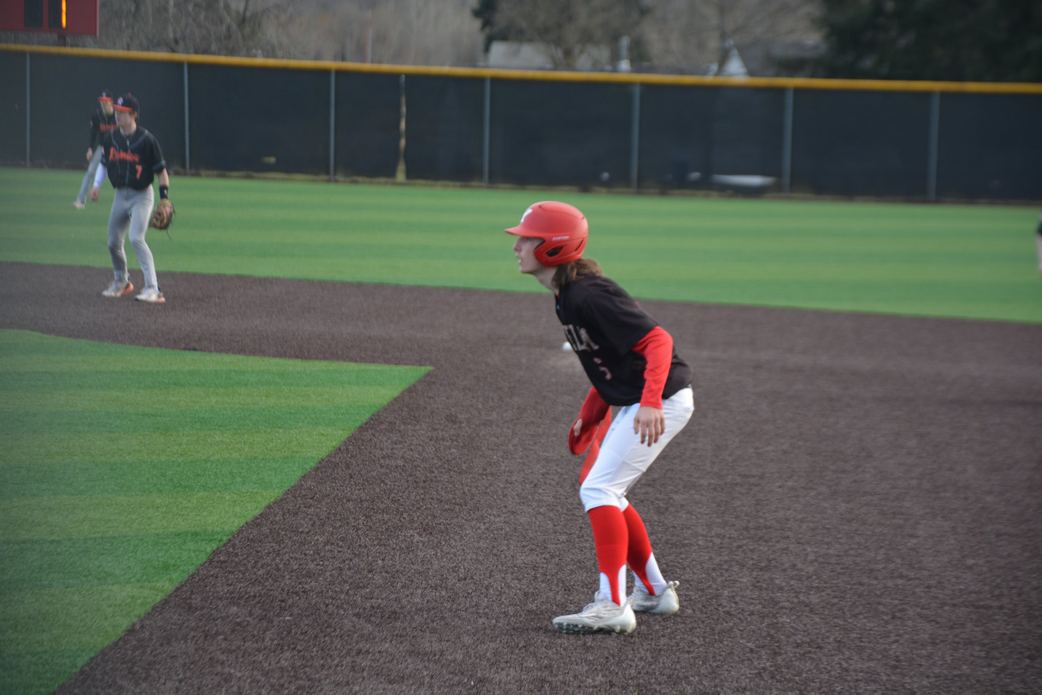 Freshman Tornado second baseman Lincoln Ramirez takes a lead at first base during a game against Rainier on Friday, March 10.
