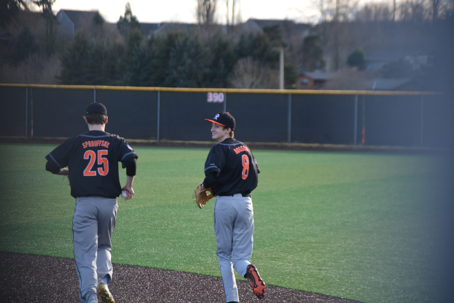 Rainier’s Jared Sprouffske and Johnny Boesch jog to the outfield to their defensive positions on Friday, March 10.