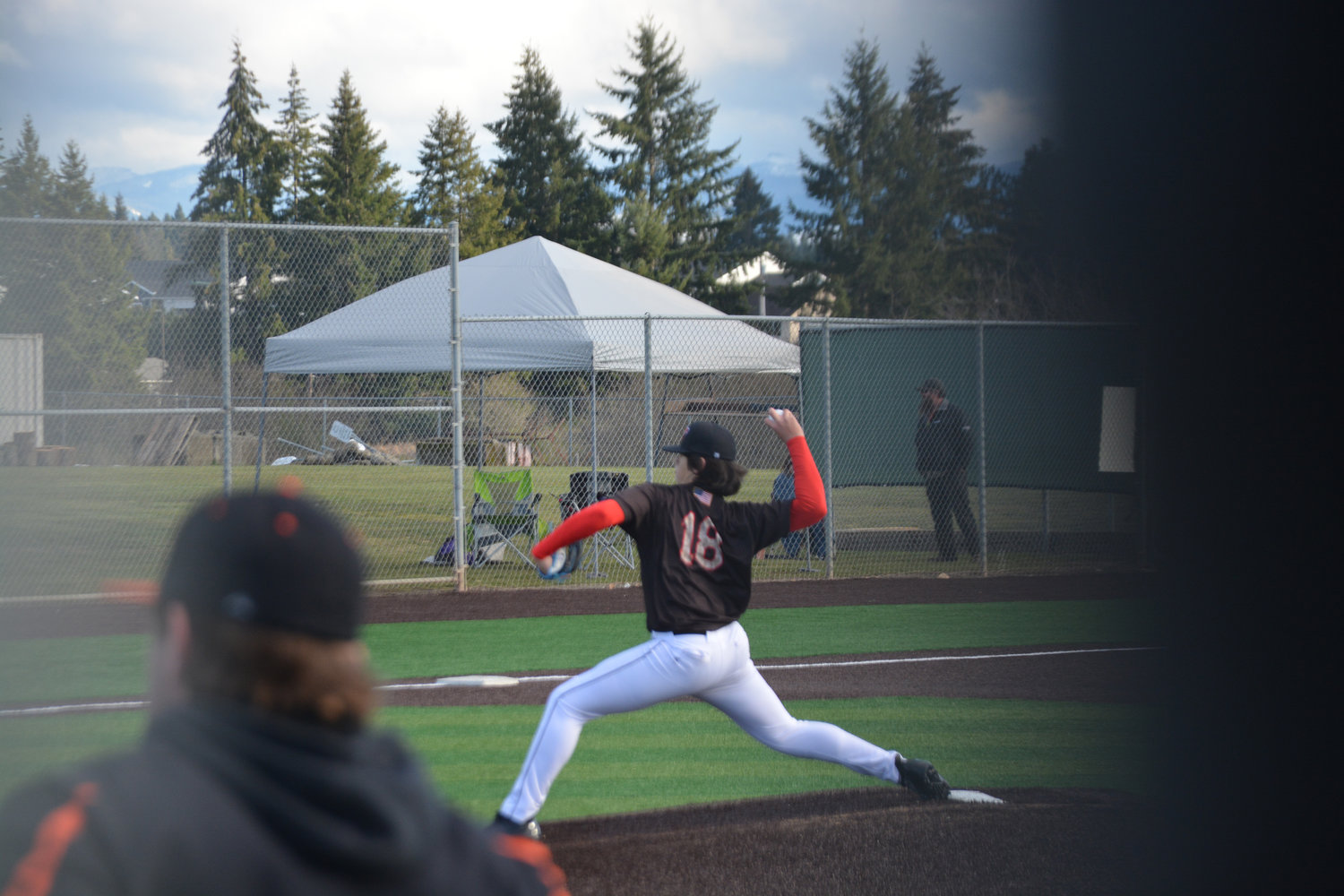 Freshman pitcher Landan Halterman delivers his first career pitch in his first start for Yelm at a game against Rainier on Friday, March 10.