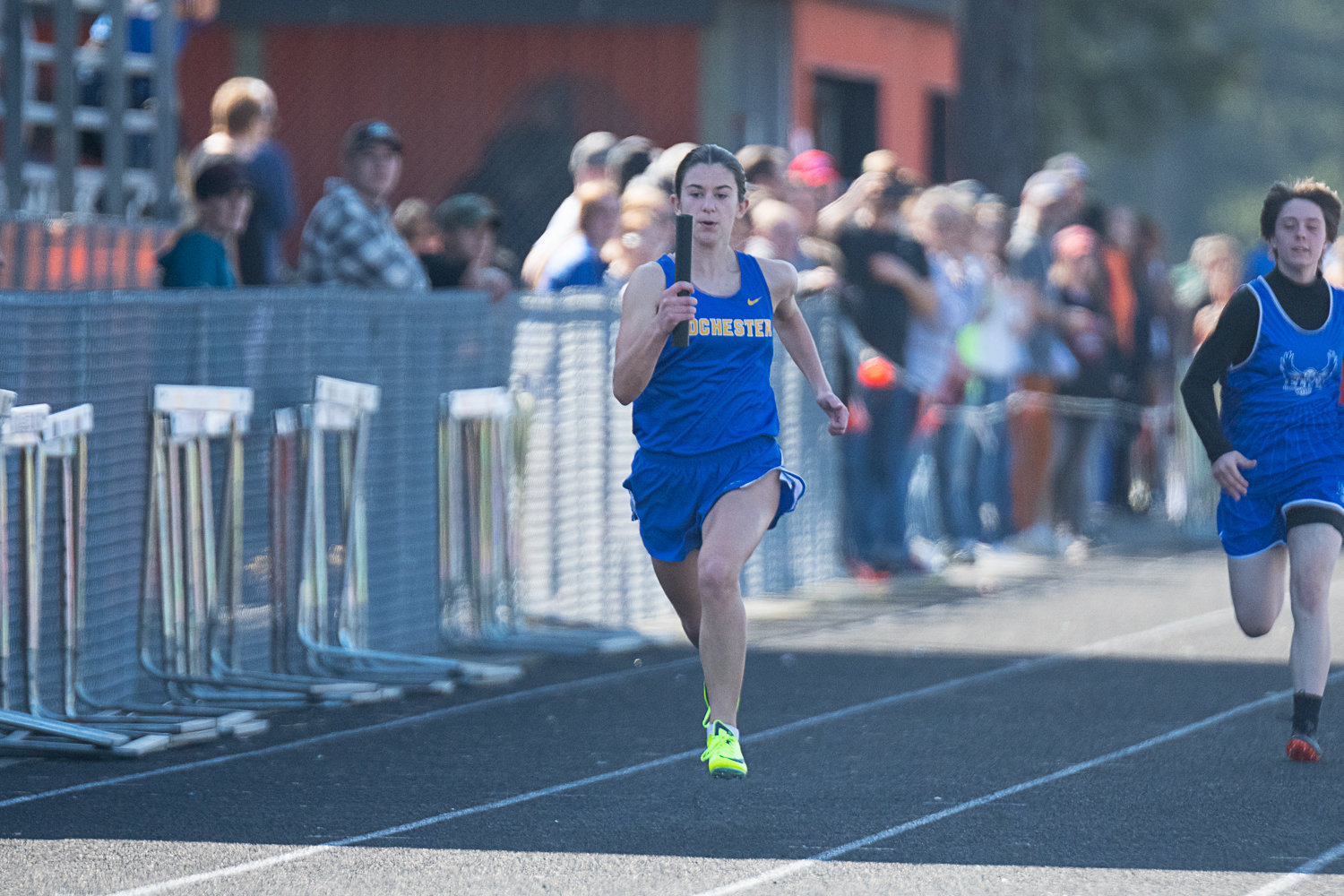 Rochester's Moran Hurst crosses the finish line during a heat in the girls 4x100 relay at the Rainier Icebreaker on March 18.