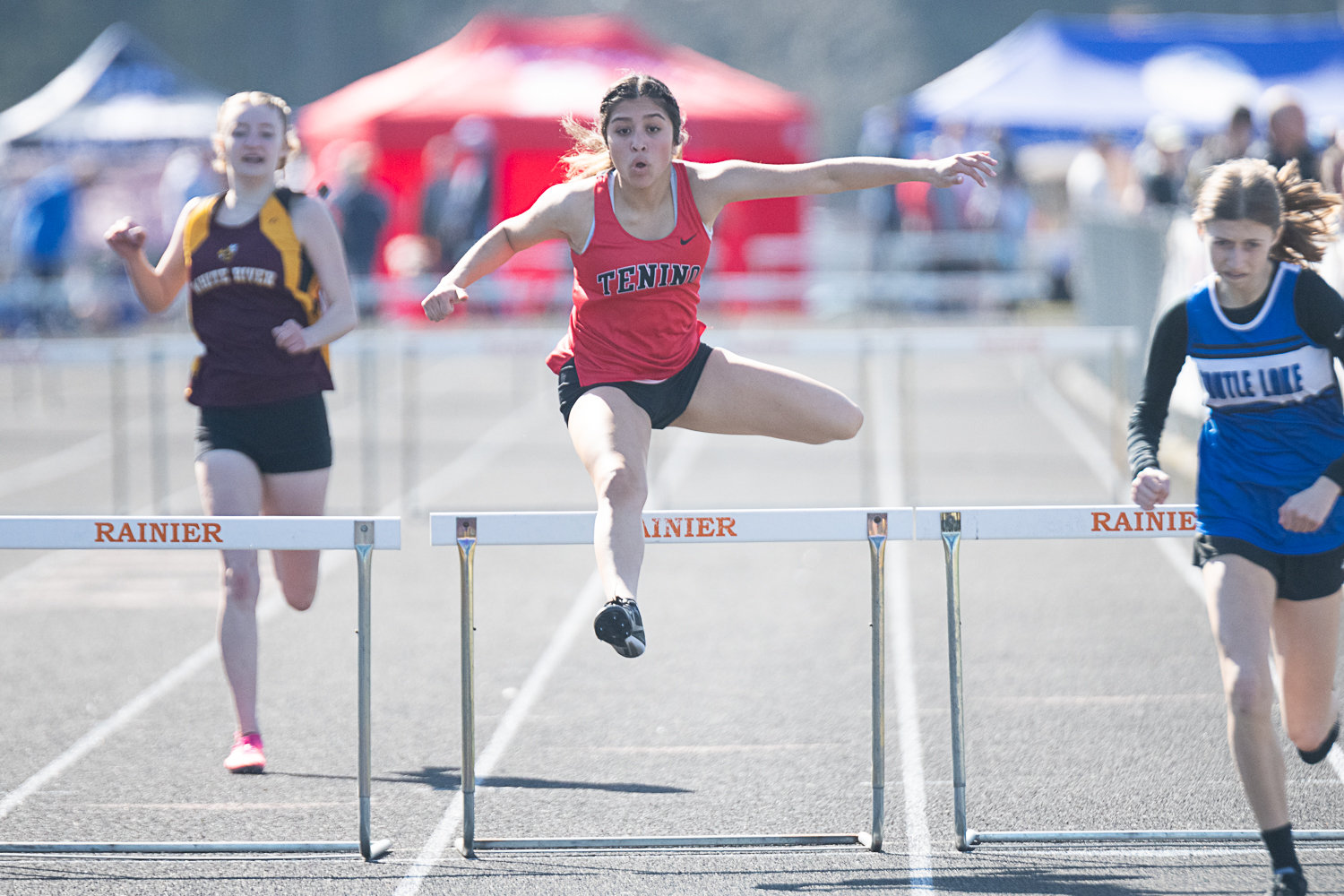 Tenino's Paisley Garcia clears a hurdle in the girls 300-meter hurdles at the Rainier Icebreaker on March 18.