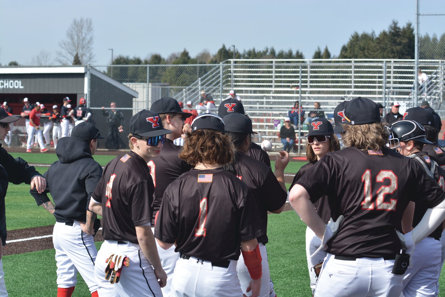 Members of the Tornados baseball team converse prior to the start of their game against Steilacoom on Friday, March 17.