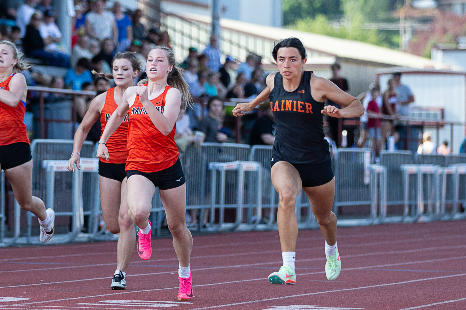 Rainier's Acacia Murphy (right) and Napavine's Morgan Hamilton are neck and neck at the finish line of the 100-meter dash May 19 at W.F. West in the 2B District 4 Championships.