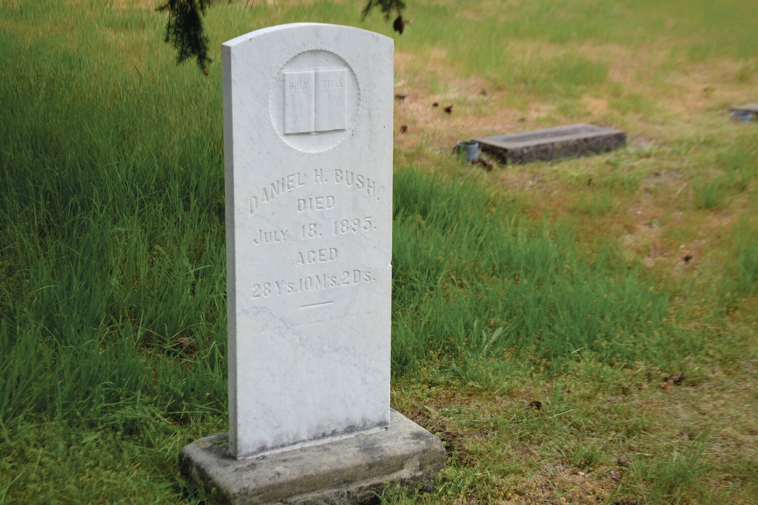 A headstone is pictured after it was cleaned a D/2 formula, which restores the surface.