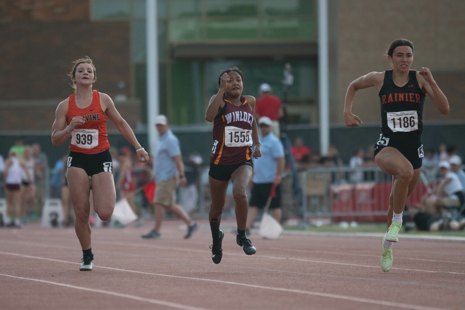 Napavine's Maddie Dickinson (left), Winlock's Victoria Sancho (center), and Rainier's Acacia Murphy (right) run in a prelim heat of the 100-meter dash at the 2B state championships at Zaepfel Stadium in Yakima on May 25.