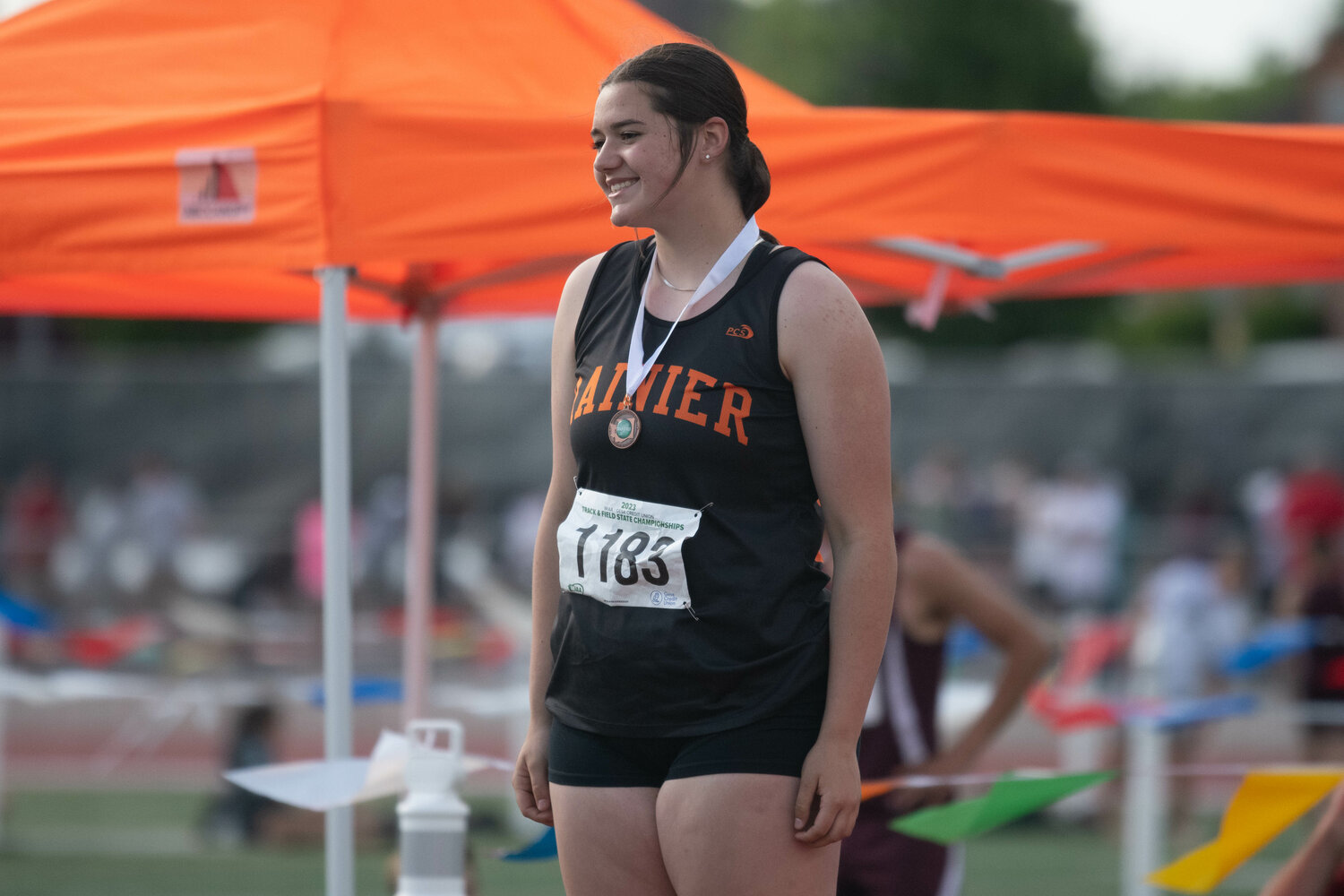 Rainier's Haleigh Hansen smiles after receiving her medal for taking seventh place in the shot put at the 2B state championships at Zaepfel Stadium in Yakima on May 25.