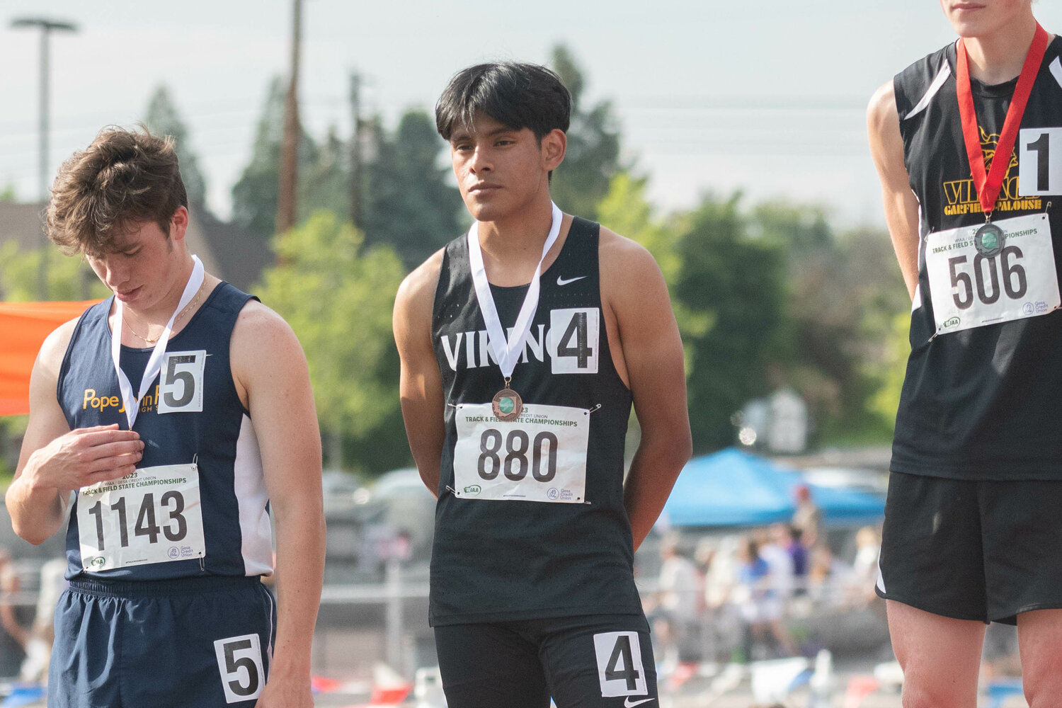 Mossyrock's Christian Paz Tapia stands on the podium with his fourth-place medal for the boys 1,600 meters at the 1B state championships at Zaepfel Stadium in Yakima on May 25.