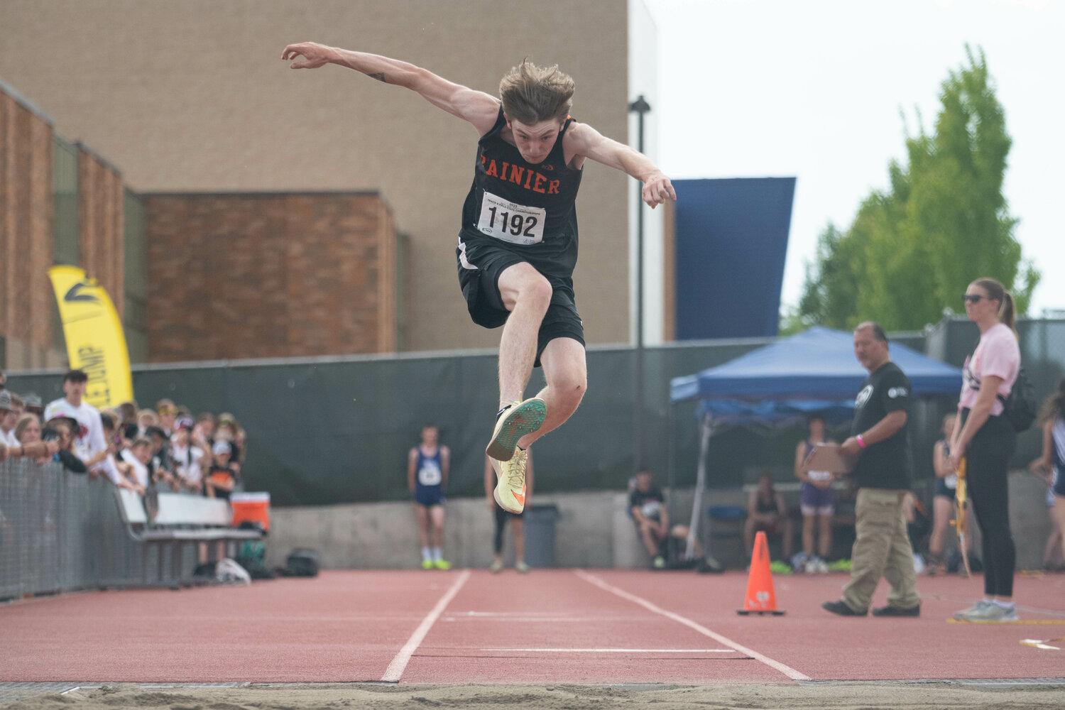 Rainier's Chase McFarland goes flying in the triple jump finals at the 2B state championships at Zaepfel Stadium in Yakima on May 25.