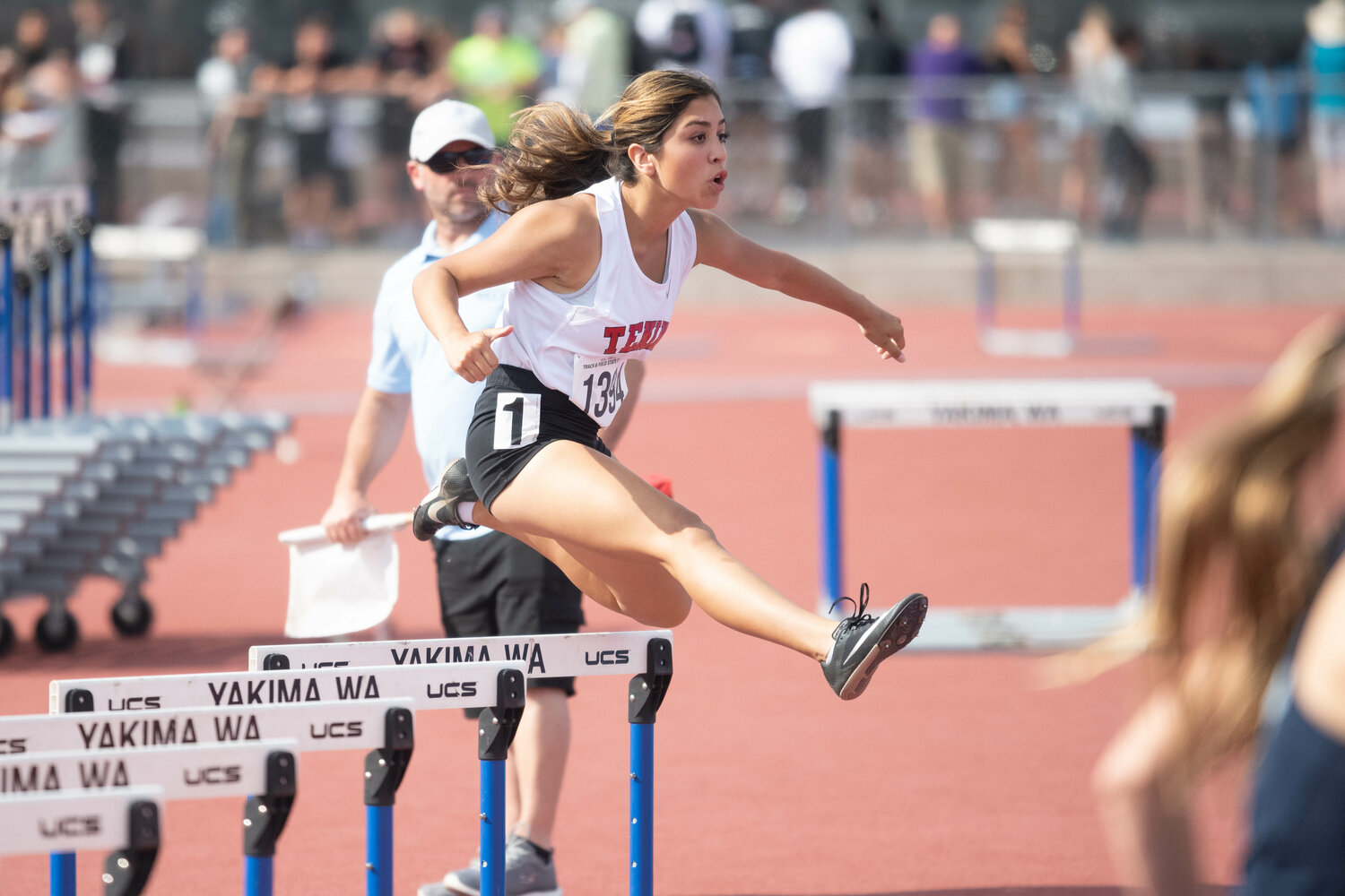 Tenino's Paisely Garcia gets into the homestretch in the 300-meter hurdles at the 1A state championships at Zaepfel Stadium in Yakima on May 25.
