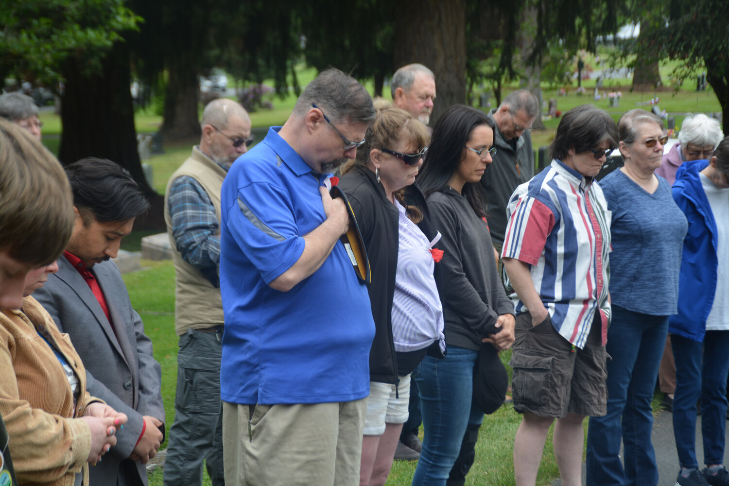 Those in attendance at a Memorial Day ceremony at the Yelm Cemetery bow their heads in prayer as Chaplain James A. Smith reads a passage.