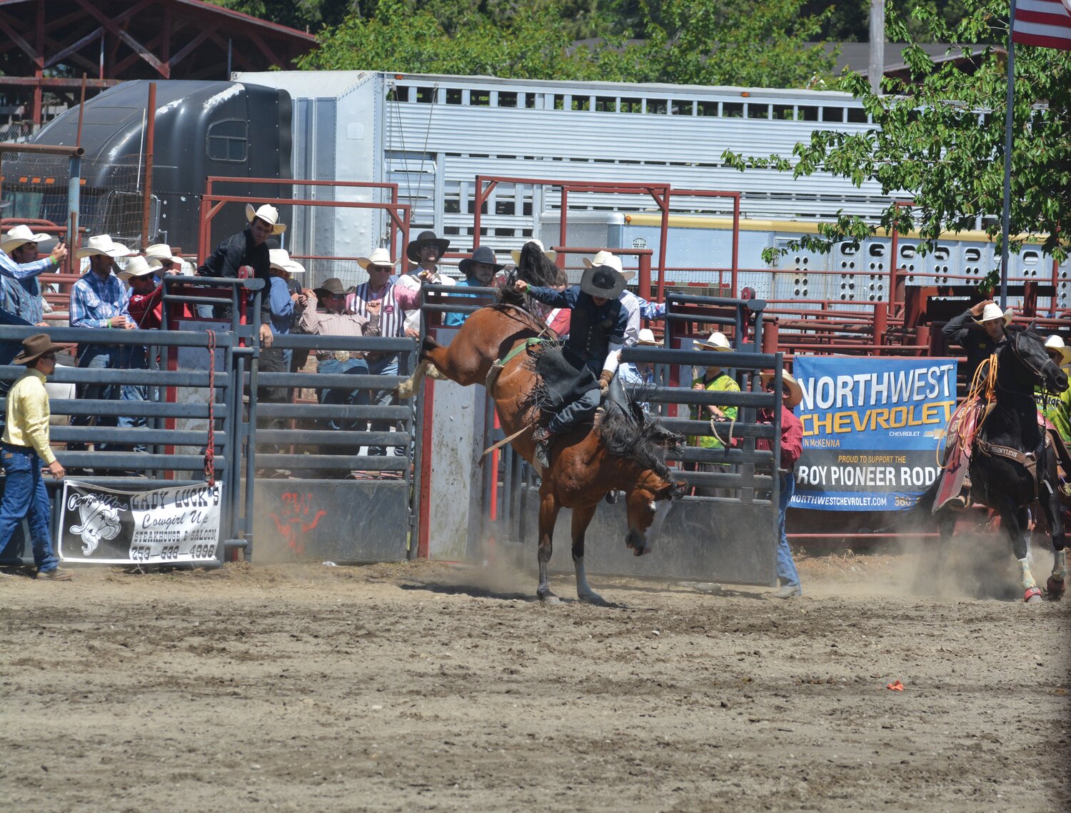 A cowboy rides a bronc during the Roy Pioneer Rodeo on Sunday, June 4.