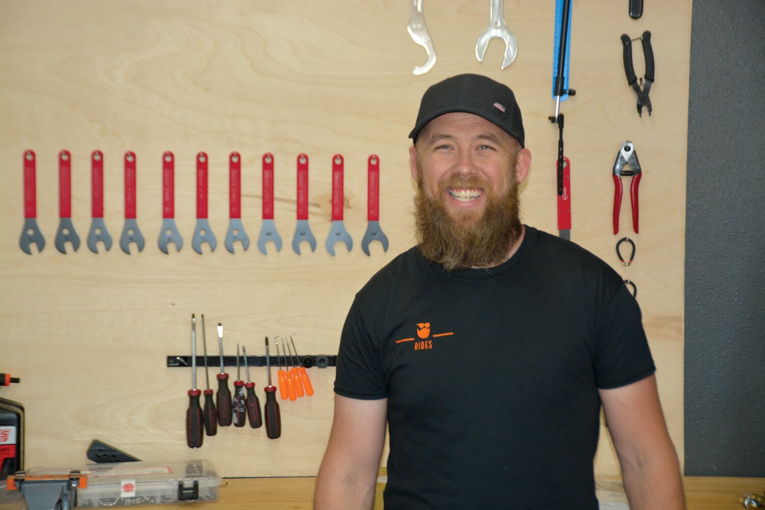 Dylan Muhle, owner of Rides Bike and Board in Yelm, smiles on July 14 in his new shop.