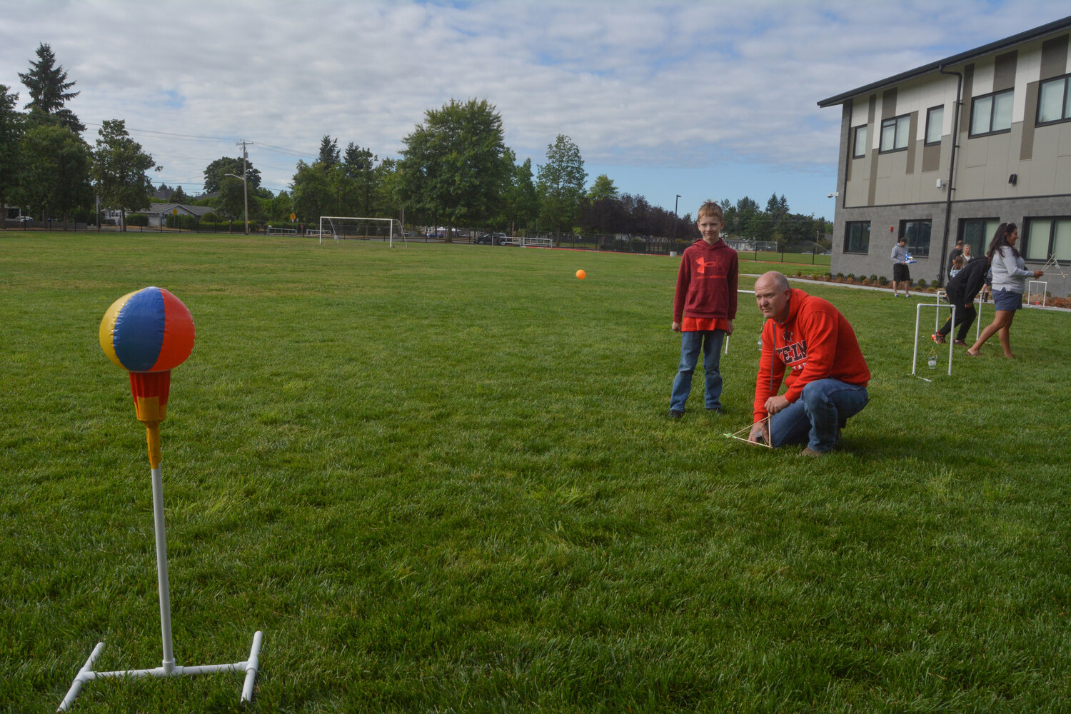 A parent takes a shot at the meteor strike activity at STEMKAMP Family Day on Aug. 11.