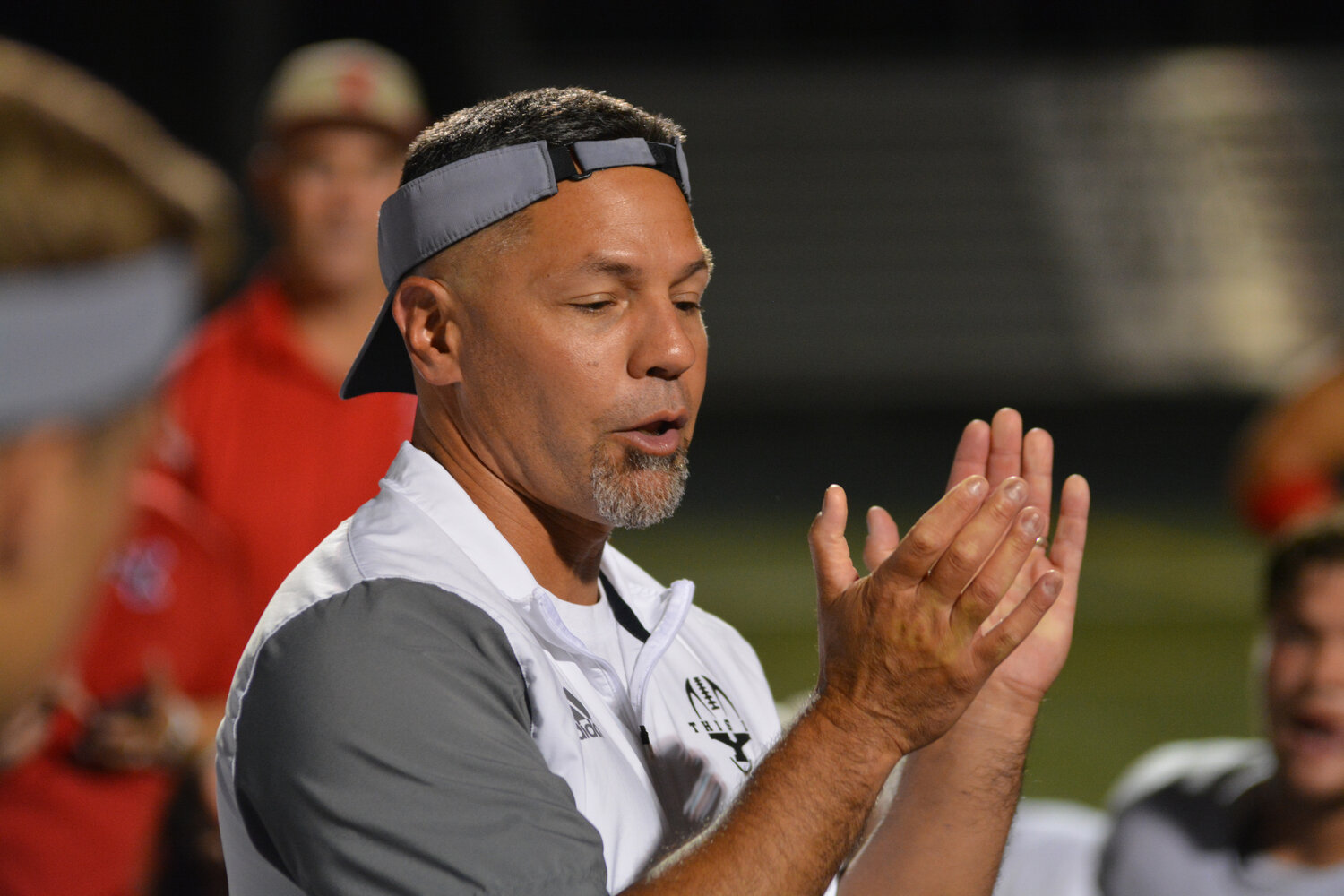 Head coach Jason Ronquillo applauds his team after an 8-7 victory over the Camas Papermakers on Sept. 1.