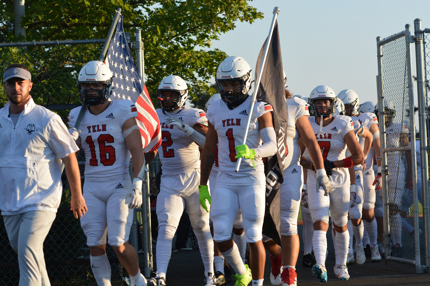 Led by coach William Benbrook, Nathan Ford (left) and Arlo Henderson Jr. (right) march the Tornados onto the field to face the Camas Papermakers on Sept. 1.