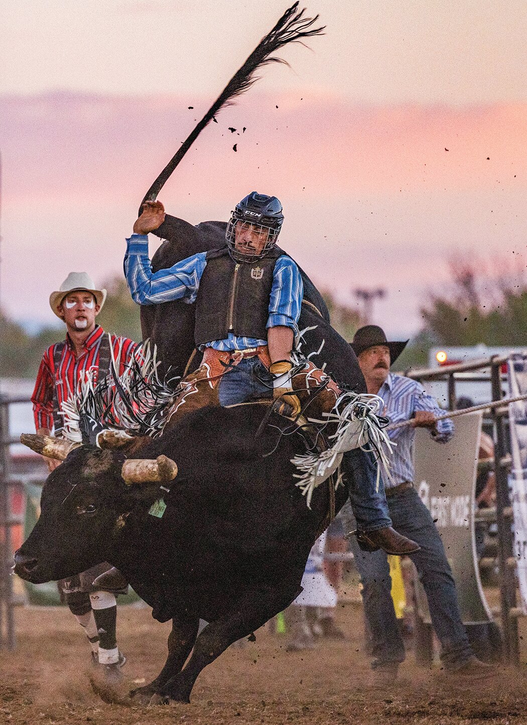 Benjamin Viveros, of Yelm, hangs on to “Flatliner” the bull during night one of rodeo events at the Southwest Washington Fair on Wednesday, Aug. 16.