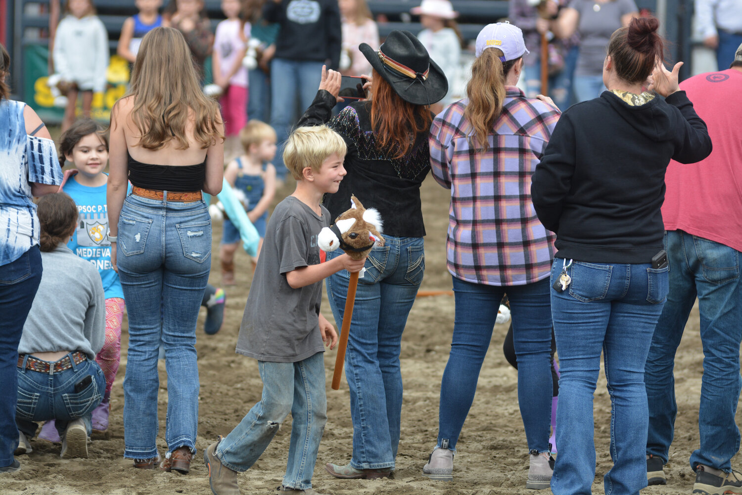 A young Roy Rodeo attendant smiles after he ran in the “Sunday horse stick race” at the Roy Rodeo on Sept. 3.
