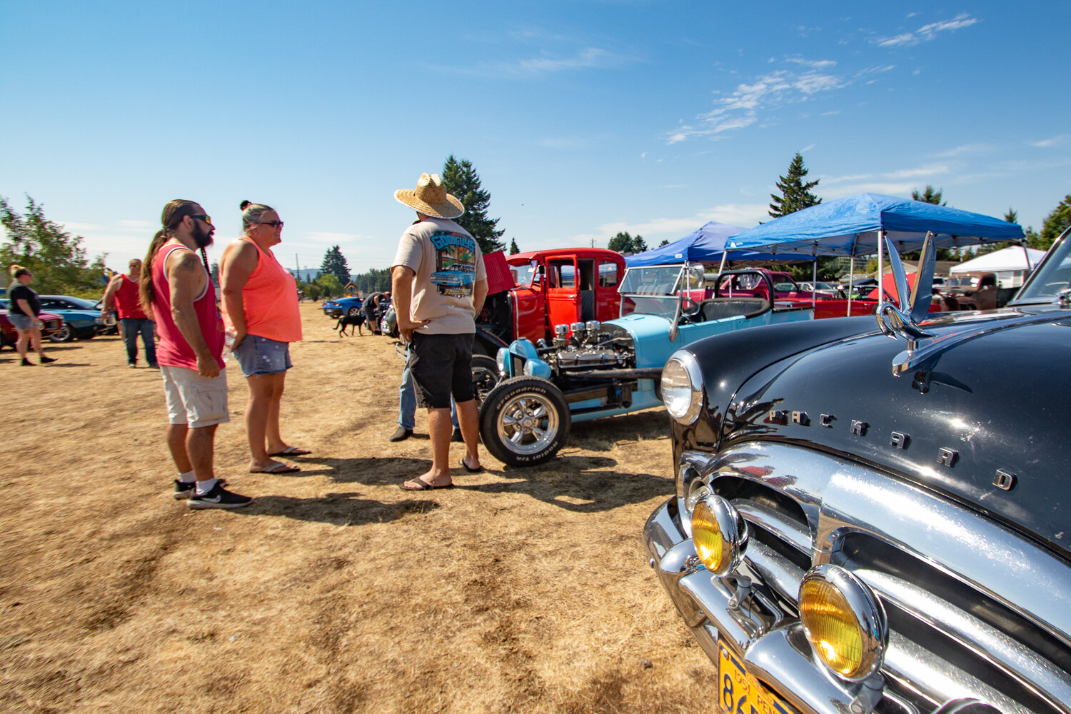 Car show attendees mingle at the 16th annual Military Heroes Car Show at Wilkowski Park in Rainier on Saturday, Sept. 2.
